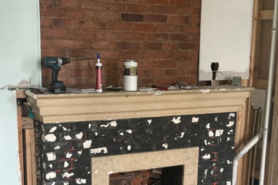 Living room photo with a tile fireplace