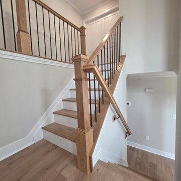Metal and Wood Indoor Railing Installation with Red Oak T-Rail & Black Balusters