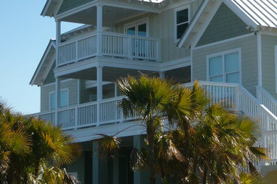 Large coastal beige three-story concrete fiberboard gable roof idea in Tampa