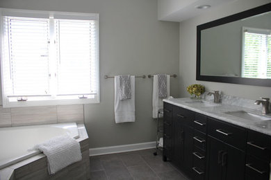Mid-sized trendy master gray tile and porcelain tile porcelain tile and gray floor bathroom photo in DC Metro with gray walls, an undermount sink, marble countertops and a hinged shower door