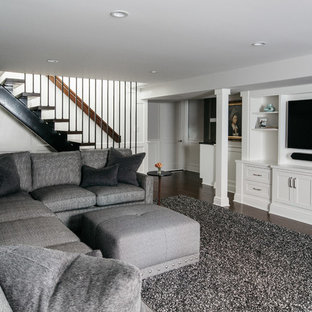 Classic basement in Chicago with grey walls, dark hardwood flooring and no fireplace.
