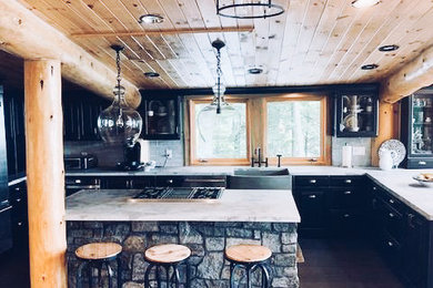 Eat-in kitchen - eclectic u-shaped dark wood floor eat-in kitchen idea in New York with a farmhouse sink, raised-panel cabinets, black cabinets, concrete countertops, gray backsplash, ceramic backsplash, stainless steel appliances, an island and gray countertops