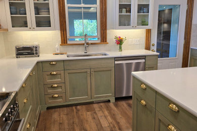 Mid-sized cottage l-shaped vinyl floor, brown floor and shiplap ceiling enclosed kitchen photo in Ottawa with an undermount sink, recessed-panel cabinets, green cabinets, quartz countertops, green backsplash, porcelain backsplash, stainless steel appliances, an island and white countertops