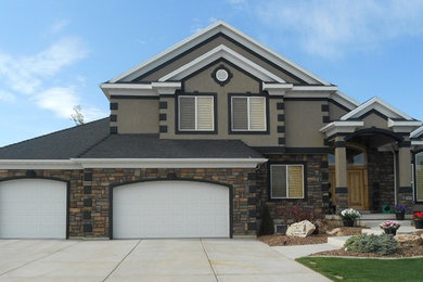 Large contemporary two-storey beige house exterior in Salt Lake City with mixed siding, a gable roof and a tile roof.