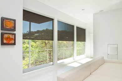 Example of a mid-sized minimalist ceramic tile and white floor living room design in Austin with white walls