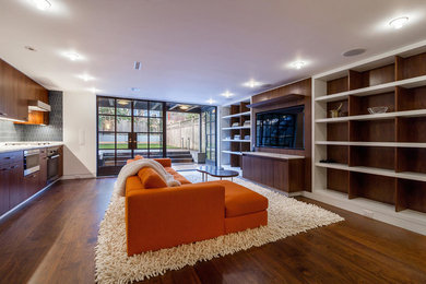 Minimalist open concept medium tone wood floor living room photo in New York with white walls and a media wall