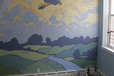 Example of a large 1950s boy dark wood floor nursery design in New York with multicolored walls