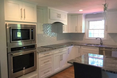 Inspiration for a kitchen remodel in Boston with shaker cabinets, white cabinets, granite countertops, white backsplash and subway tile backsplash