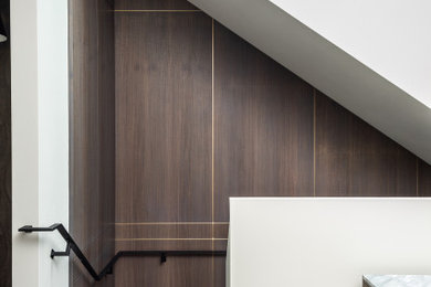 This is an example of a large contemporary wood l-shaped staircase in San Francisco with wood risers and metal railing.
