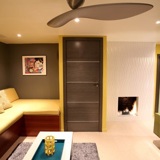 This is an example of a large retro enclosed home cinema in Los Angeles with yellow walls, cork flooring and a wall mounted tv.