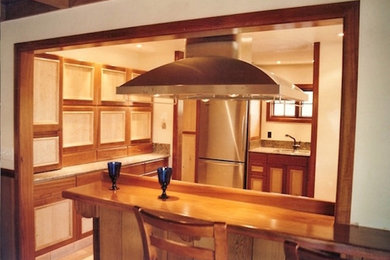 Arts and crafts light wood floor and beige floor kitchen photo in Hawaii with an undermount sink, flat-panel cabinets, light wood cabinets, granite countertops, beige backsplash, wood backsplash, stainless steel appliances and no island