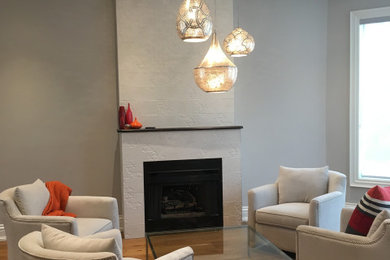 Living room - transitional light wood floor and brown floor living room idea in Toronto with a tile fireplace