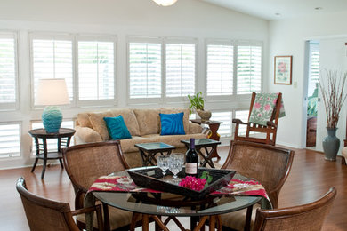 Design ideas for a mid-sized tropical open plan dining in Hawaii with white walls, medium hardwood floors and brown floor.