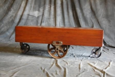 Walnut coffee table with salvaged iron wheels