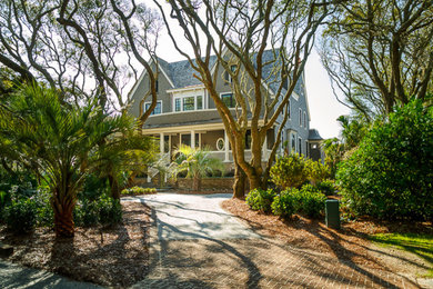 Large traditional brown three-story wood gable roof idea in Charleston