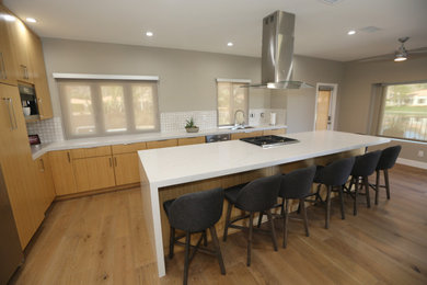 Mid-sized minimalist l-shaped eat-in kitchen photo in Orange County with an undermount sink, quartz countertops, multicolored backsplash, mosaic tile backsplash, stainless steel appliances, an island and white countertops