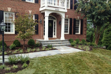 Photo of a mid-sized transitional full sun front yard landscaping in DC Metro for spring.