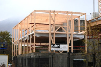 Foto de fachada contemporánea de tres plantas con revestimiento de madera y tejado plano