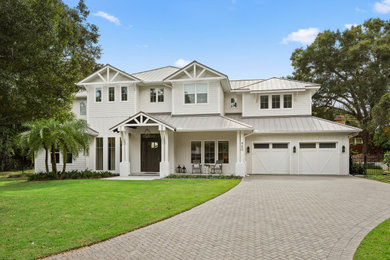 This is an example of a large coastal front yard stone driveway in Orlando.