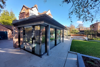 Contemporary glazed extension connects historic house to garden