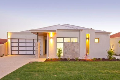 This is an example of a small contemporary one-storey concrete beige exterior in Perth with a hip roof.