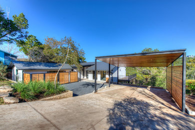 Example of a large trendy white two-story stucco gable roof design in Austin