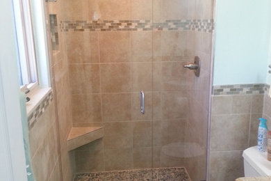 Inspiration for a mid-sized transitional 3/4 beige tile and porcelain tile porcelain tile and beige floor alcove shower remodel in Other with raised-panel cabinets, white cabinets, a two-piece toilet, blue walls, an undermount sink, laminate countertops and a hinged shower door
