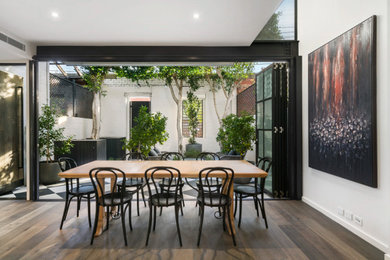 Inspiration for a mid-sized contemporary dining room in Melbourne with dark hardwood floors.