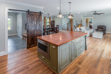 Inspiration for a country l-shaped light wood floor kitchen remodel in DC Metro with wood countertops and an island