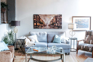 Inspiration for a timeless light wood floor family room remodel in Calgary with white walls