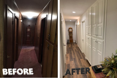Hallway - mid-sized traditional laminate floor and brown floor hallway idea in Little Rock with beige walls