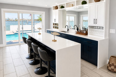 Example of a beach style home bar design in Tampa