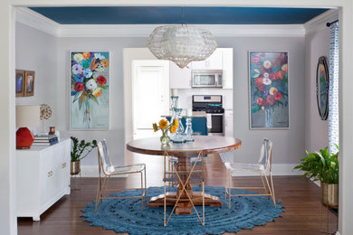 Mid-sized eclectic medium tone wood floor and brown floor kitchen/dining room combo photo in Atlanta with gray walls