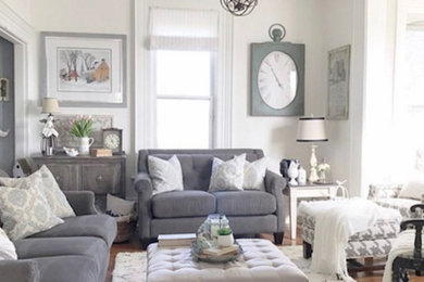 Example of a mid-sized cottage chic formal medium tone wood floor living room design in Toronto with no tv and white walls