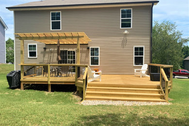 Design ideas for a large classic back ground level mixed railing terrace in Raleigh with a pergola.