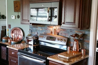 Eat-in kitchen - mid-sized contemporary l-shaped porcelain tile eat-in kitchen idea in Philadelphia with a double-bowl sink, beaded inset cabinets, medium tone wood cabinets, granite countertops, beige backsplash, stone tile backsplash, stainless steel appliances and an island