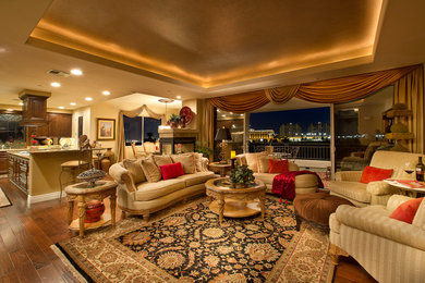 Large elegant formal and open concept medium tone wood floor living room photo in Las Vegas with no tv, beige walls, a two-sided fireplace and a stone fireplace