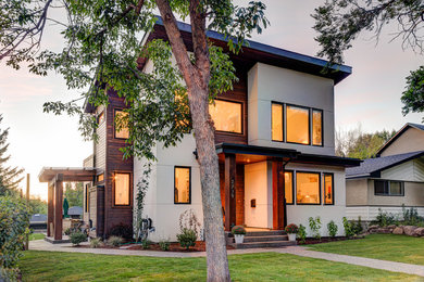 Trendy two-story mixed siding exterior home photo in Calgary with a shed roof