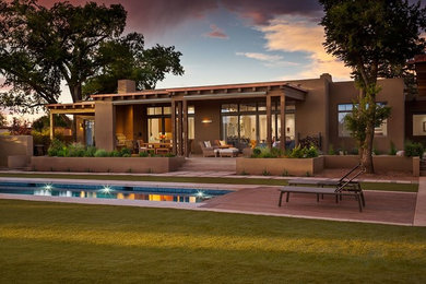 Mid-sized contemporary brown one-story stucco flat roof idea in Albuquerque