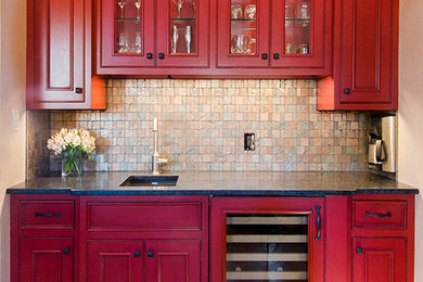 Inspiration for a mid-sized transitional single-wall medium tone wood floor wet bar remodel in Albuquerque with an undermount sink, glass-front cabinets, granite countertops, multicolored backsplash and glass tile backsplash