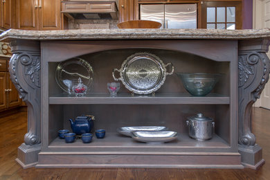 Large elegant light wood floor and brown floor eat-in kitchen photo with an undermount sink, raised-panel cabinets, medium tone wood cabinets, quartz countertops, beige backsplash, stainless steel appliances, an island and beige countertops