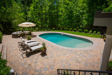Concrete paver and round pool photo in Cincinnati