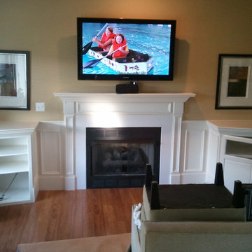 Built In Shelving and Cabinets To Hide Electronics and Surround Fireplace
