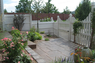 Small elegant backyard stamped concrete patio photo in Denver