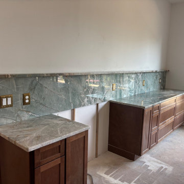 Green quartzite kitchen with full-height slab backsplash