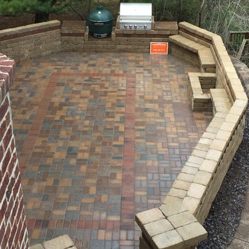 Outdoor Kitchen with fireplace, dining area and seating wall