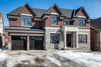 Transitional two-story stone exterior home photo in Toronto