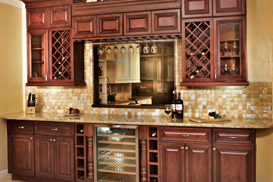 Example of a classic single-wall ceramic tile and beige floor home bar design in New Orleans with an undermount sink, raised-panel cabinets, dark wood cabinets, granite countertops, beige backsplash and mosaic tile backsplash