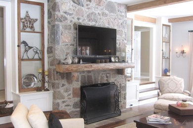 Large elegant open concept medium tone wood floor living room photo in Toronto with a standard fireplace, a stone fireplace and a wall-mounted tv