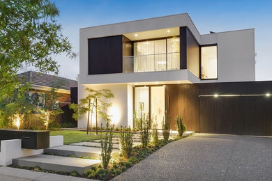 Modern two-storey white house exterior in Melbourne with wood siding, a flat roof and a metal roof.